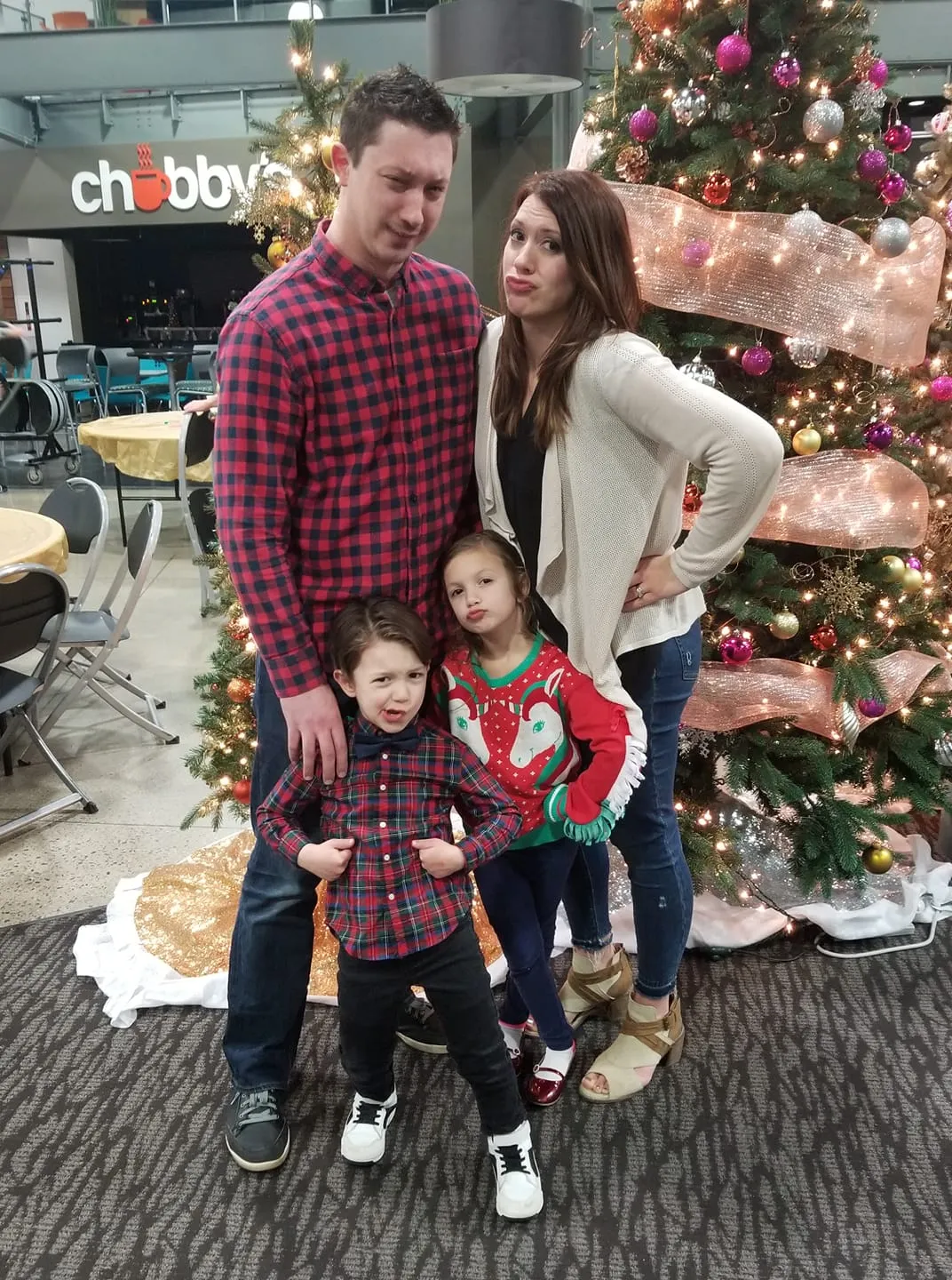 Matt Cramer with his family in front of a Christmas tree